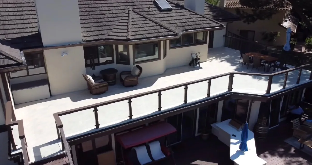 Aerial view of a wraparound upper deck with glass panel railing and bronze posts
